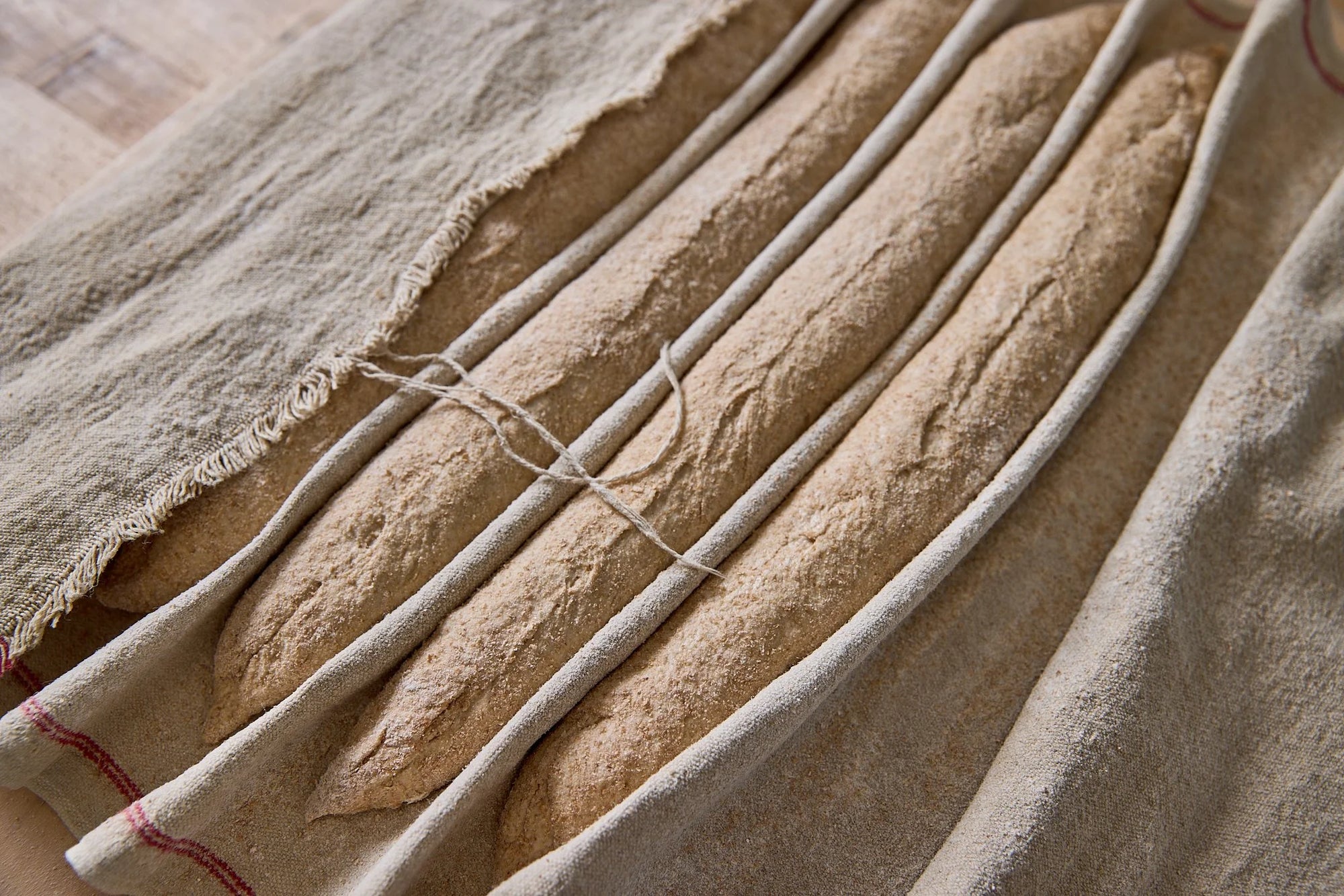 Unbaked baguettes covered in flour